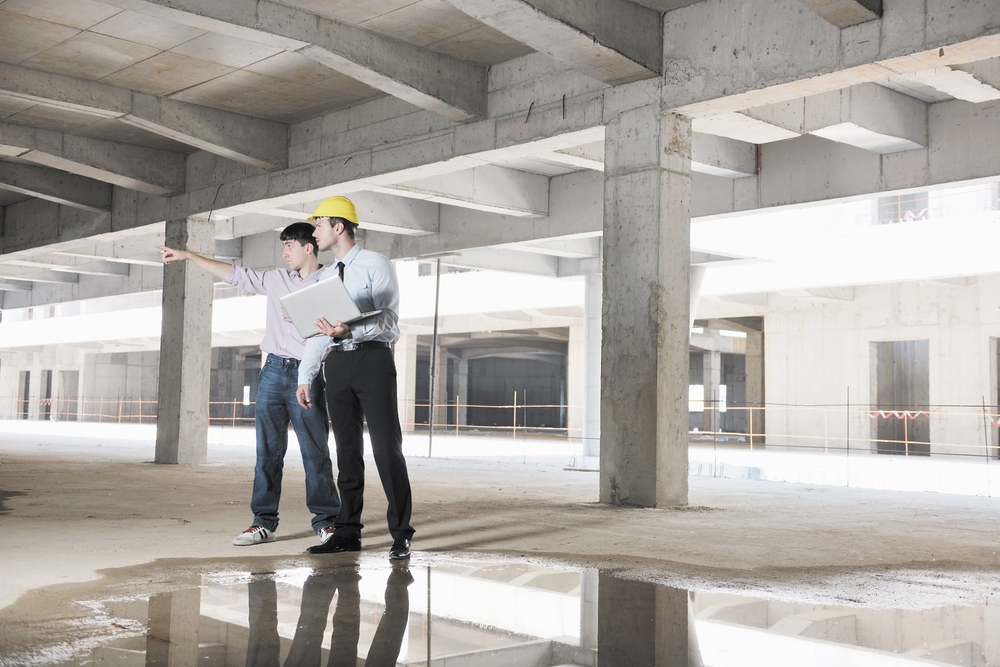 Team of business people in group, architect and engeneer on construciton site check documents and business workflow on new building Team of business people in group, architect and engeneer on construciton site check documents and business workflow on new building